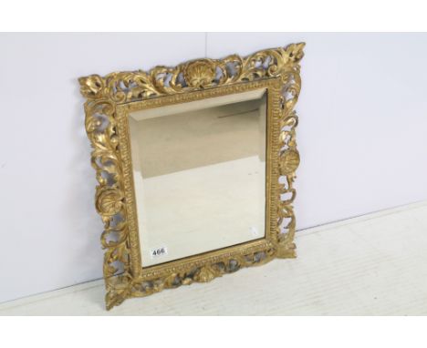 Late 19th century giltwood mirror, the pierced border moulded with foliage and shells, with bevelled glass plate, 54 x 47cm