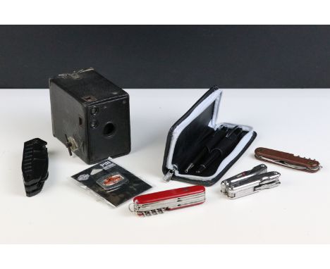 A small group of collectables to include a box camera, three penknives and a pen set.