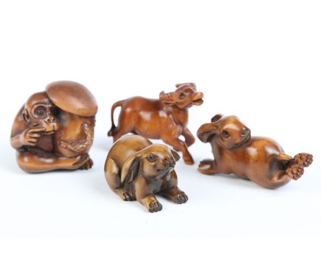 A group of four fruit wood signed netsuke. 