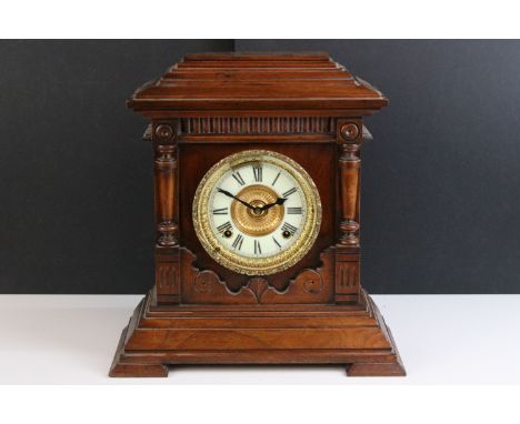 Late 19th century/ early 20th century Ansonia, New York, oak cased mantel clock with carved column details to sides and a bra