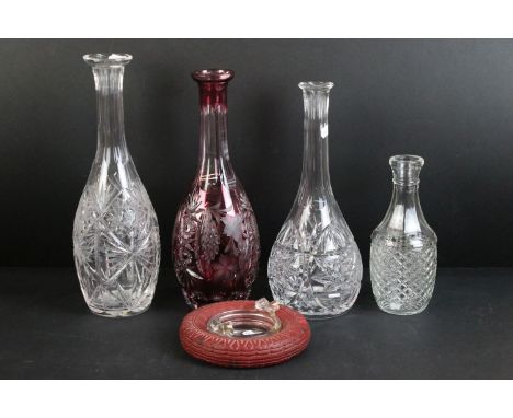 Cranberry ruby etched glass wine decanter with grape and leaf design together with two cut glass decanters, one smaller press