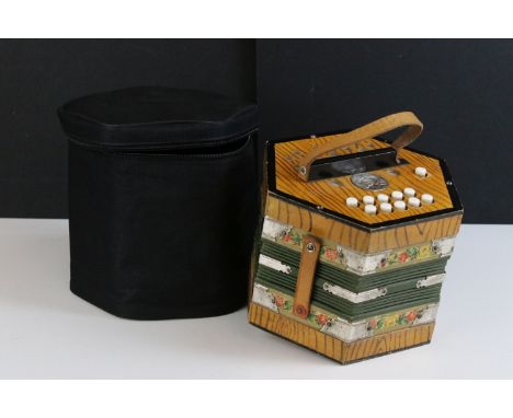 German Scholer concertina, 21 buttons, with floral borders, checked lining, green bellow and decorative corner mounts complet