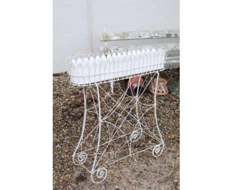 20th Century vintage planter on stand having a scrolled metal base with scalloped top oval planted to top. Measures 97 x 93cm