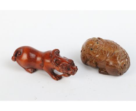 Two carved wooden netsuke figures of a Chinese dragon to include one eating fruit 