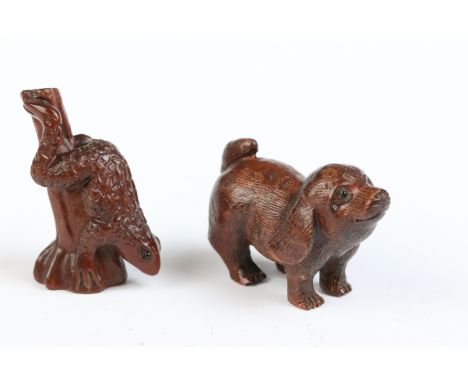 Two carved wooden netsuke figures to include dog and a frog on stick 