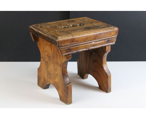 19th century elm and beech stool with three finger holes to seat, 28cm high x 29cm wide