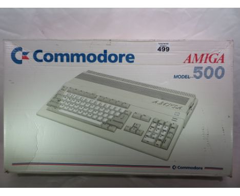 A Commodore Amiga 500, boxed, with large assortment of games. Please note that buyer must arrange collection of this item.