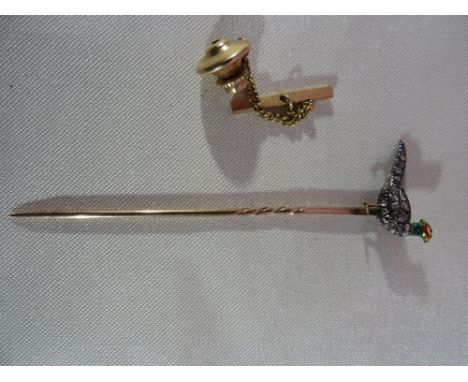 A diamond and enamel pheasant set stickpin, with rose cut diamonds and green, red and yellow enamelled head, all set in yello