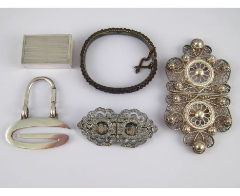 A mixed lot comprising a paste set Art Deco double clip brooch, a white metal (tests silver) filigree buckle, a “Bohemian” ga