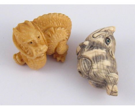 Two netsuke, circa 1920. A leaping boar and a dragon, both signed. 
