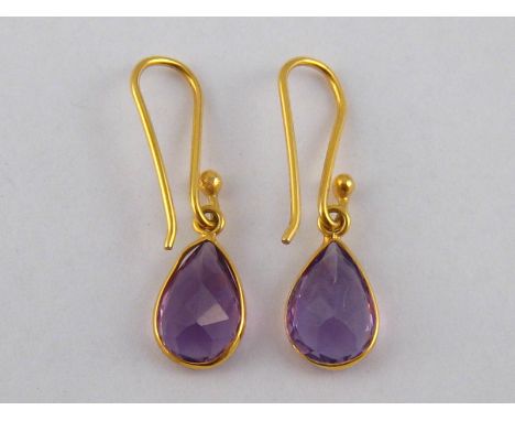 A pair of yellow metal (tests 18 carat gold) amethyst earrings, drop approx 2.5cm, 1.3 gms.
