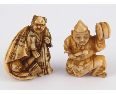 Two ivory netsuke, circa 1920,one an entertainer with drum , the other a man with sack, broken open revealing another figure 