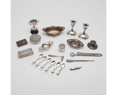 a pair of dwarf candlesticks (loaded), an inkwell (loaded), a strainer, two mounted glass jars, a small trophy cup, a pierced