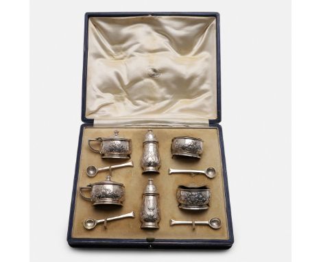 with hammered finishing, the mustard pots embossed with clovers, the salts with Tudor roses, (blue glass liners) and the pepp
