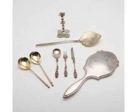 a George V mounted hand mirror, with engine-turned decoration, a continental three-piece christening set, decorated in high r