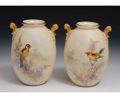 A pair of Royal Worcester and Grainger Co two handled blush ivory small vases each painted with birds and blossom, 12cm high