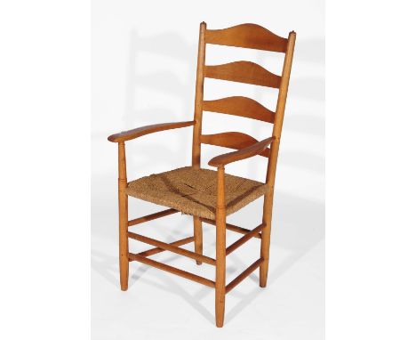 A Cotswold style armchair with ladder back and curved open arms on rush seat and turned legs, 106cm high