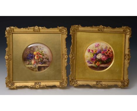 A pair of Royal Worcester porcelain painted roundels one painted with a bouquet of flowers, signed E Philips, the other a bas
