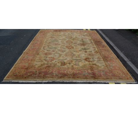 A large Persian carpet of ivory ground with foliate designs, 376cm x 264cm