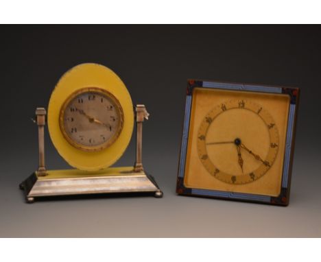 An Art Deco style clock in the form of a toilet mirror with silver frame, yellow enamelled decoration and engine turned finis