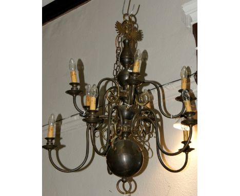 A Dutch style brass chandelier with double eagle finial and with scroll branches, 94cm high