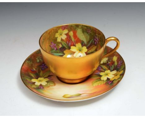 A Royal Worcester cabinet cup and saucer painted with flowers signed 'twin'