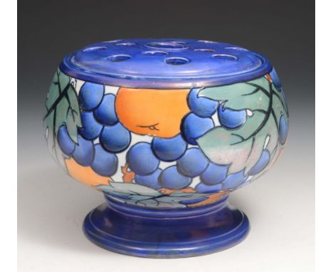 A Burleigh ware blue ground flower vase designed by Charlotte Rhead, having a pierced cover and decorated with fruit and leav