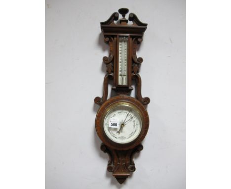 An Early XX Century Oak Aneroid Two Dial Barometer, with a broken pediment, decorated C and S scrolls, temperature gauge, ena
