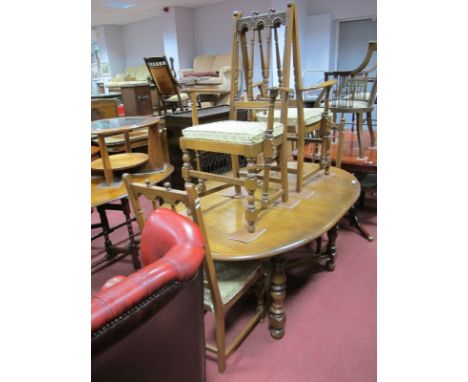 Ercol "D" End Extending Dining Table, on turned supports united by X stretchers, and two carver and two single chairs. 