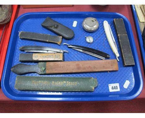 Three Early XX Century Cutthroat Razors, including white xylonite and black vulcanite examples, strop, compass, guage and pla