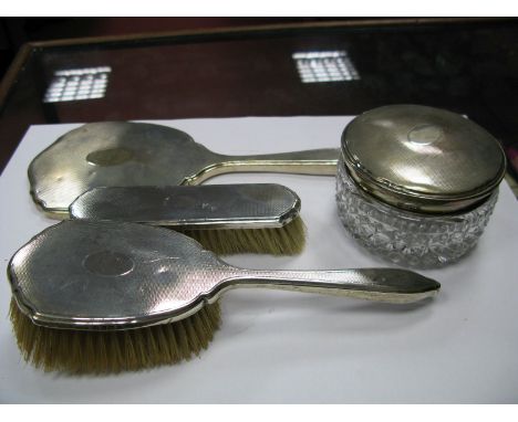 A Matched Hallmarked Silver Backed Part Dressing Table Set, each engine turned; together with matching glass trinket box. (4)