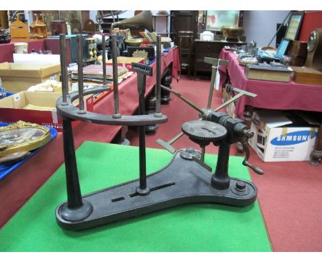 A Cast Iron and Brass Bobbin Winder, circa 1900, with seven vertical spindles to horseshoe support, silvered cog, numbered 20