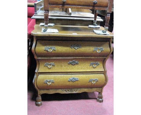 A XX Century Dutch Style Bombe Commode, with a serpentine shaped top, three long drawers, on claw and ball feet.