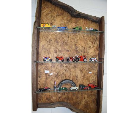 Rustic wall shelf with a quantity of model cars and motorbikes