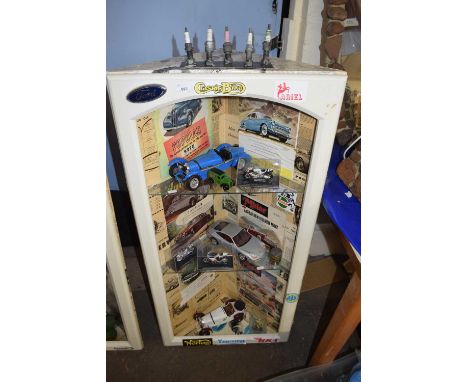 Motoring interest - a corner cabinet decorated with motoring ephemera toether with shelf contents of cars, glass ware etc