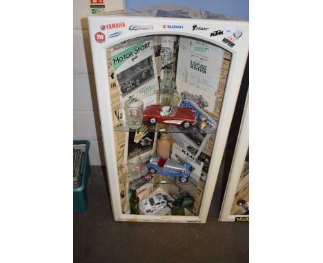 Motoring interest - a corner cabinet decorated with motoring ephemera together with shelf contents of cars, glass ware etc