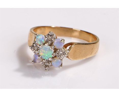 9 carat gold opal ring, with a flower head design, ring size M