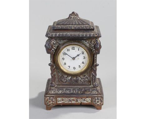 Early 20th Century mantel clock, of small proportions, the stepped top above a white enamel dial