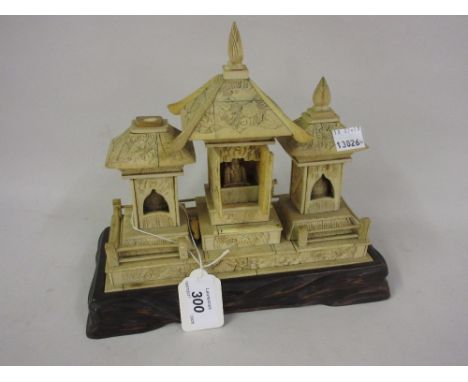 Late 19th or early 20th Century Japanese carved bone model of a Buddhistic shrine on a carved wooden stand