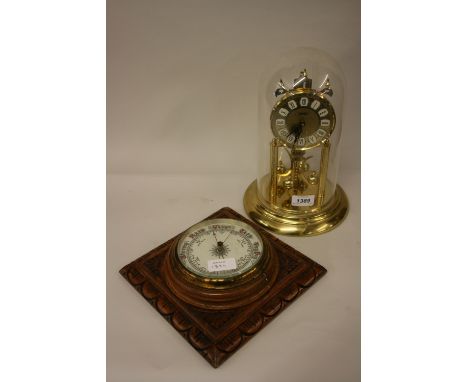 Edwardian carved oak aneroid barometer and a brass three hundred day clock
