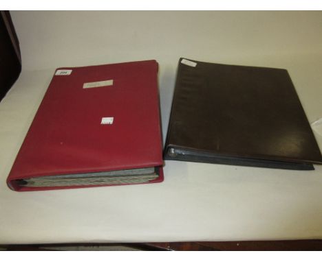 Red stock book of stamps together with a brown album of First Day covers