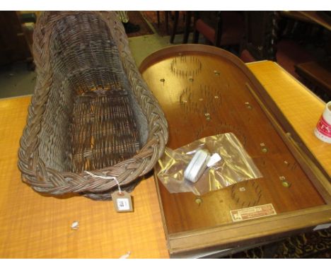 Dolls wicker cot, a mid 20th Century bagatelle and a Philips type 7424 hand powered torch