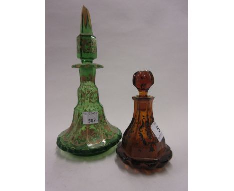 Miniature Bohemian amber glass decanter with stopper together with a similar green and gilt glass decanter with stopper (a/f)