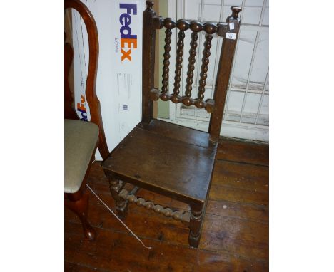 Late 18th / early 19th Century oak hall chair having bobbin turned back on turned supports with stretchers