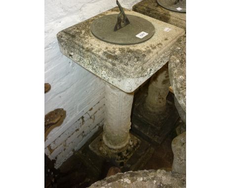 Weathered cast concrete garden sundial having ornate column support with classical figures and stepped base