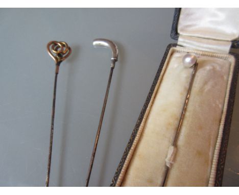 Early 20th Century hat pin with silver golf club finial, together with another hat pin (a/f) and a cased stick pin