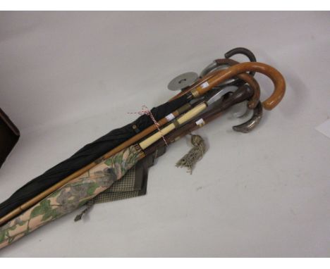 Silver mounted walking cane together with a quantity of other canes, umbrellas and a shooting stick