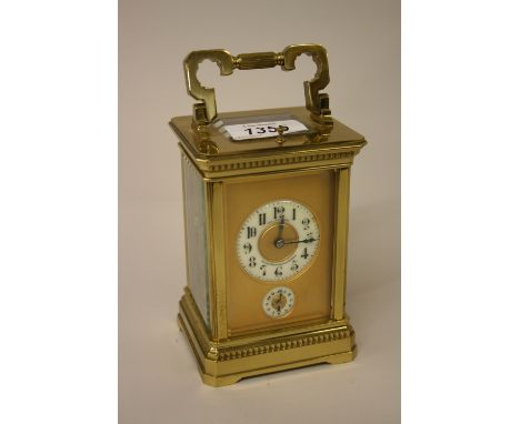 French gilt brass carriage clock, the ceramic dial with Arabic numerals with subsidiary alarm and repeat function