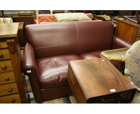 Modern burgundy leather upholstered two seater sofa by Wesley-Barrell