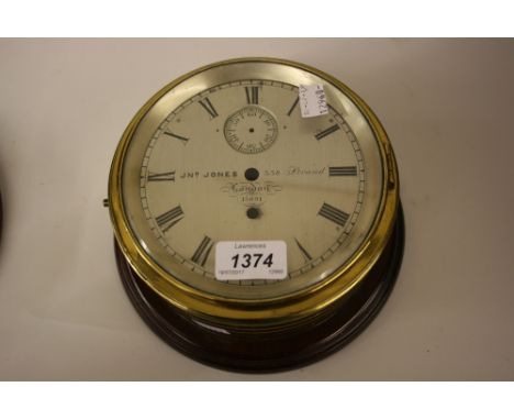 19th Century circular gilt brass ship's clock case, the silvered dial inscribed Jones, London, No. 1509 with a later mahogany